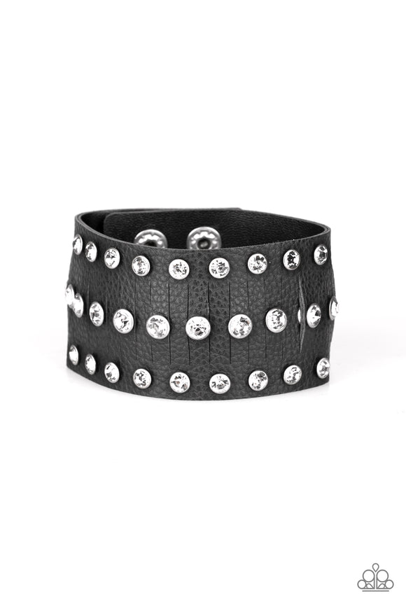 Pressed into sleek silver frames, glittery white rhinestones are studded across a thick black leather band featuring a center lined with slits for a sassy finish. Features an adjustable snap closure.  Sold as one individual bracelet.