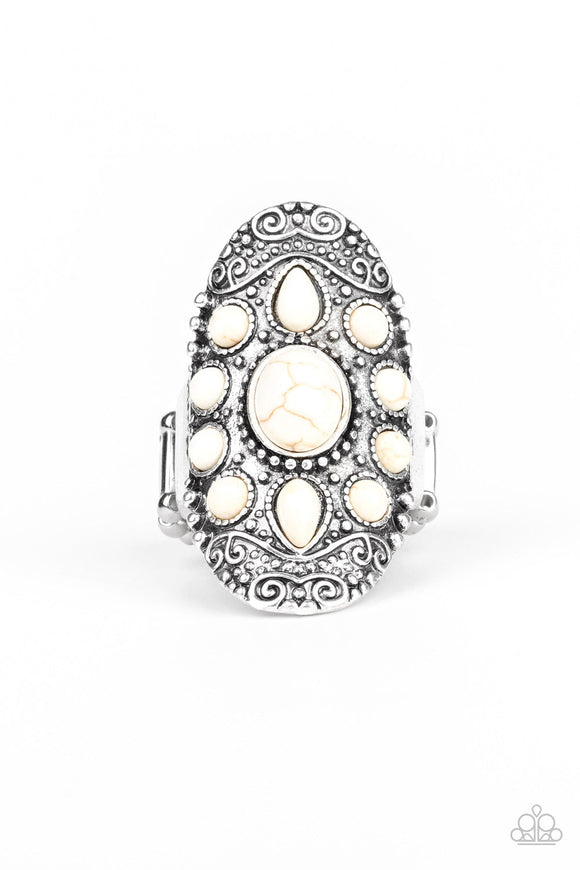 Embossed in a studded filigree pattern, an oval silver frame folds around the finger. Featuring round, oval, and teardrop shapes, refreshing white stone beads are pressed into the center of the frame, creating a whimsical floral pattern. Features a stretchy band for flexible fit.  Sold as one individual ring.