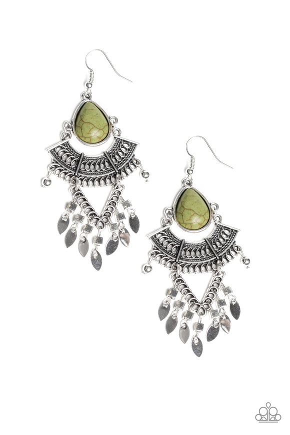 An earthy green teardrop stone gives way to a stack of linked silver frames featuring bold tribal inspired patterns. Infused with glistening silver cube beads, a fringe of flat silver beads swing from the bottom for a flirtatiously wanderlust finish. Earring attaches to a standard fishhook fitting.  Sold as one pair of earrings.