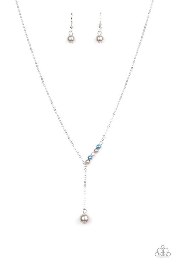 A solitaire silver pearl swings from the bottom of a glistening silver chain, creating a timeless extended pendant below the collar. A section of dainty silver and blue pearls dot one side of the chain for a refined asymmetrical finish. Features an adjustable clasp closure.  Sold as one individual necklace. Includes one pair of matching earrings.