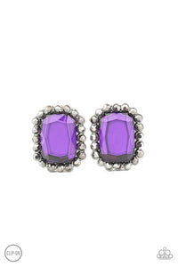 A regal purple gem is bordered by a frame of glittery hematite rhinestones for an edgy look. Earring attaches to a standard clip-on fitting.  Sold as one pair of clip-on earrings.