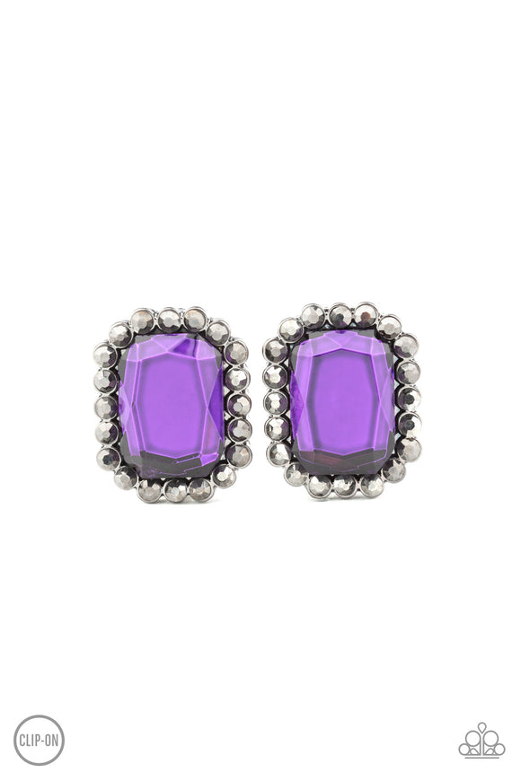 A regal purple gem is bordered by a frame of glittery hematite rhinestones for an edgy look. Earring attaches to a standard clip-on fitting.  Sold as one pair of clip-on earrings.