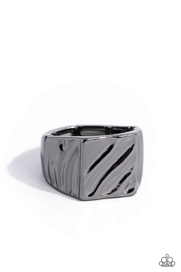 Brushed in a high sheen shimmer, a squared gunmetal band is embossed in rippling details for a tactile finish. Features a stretchy band for a flexible fit.  Sold as one individual ring.