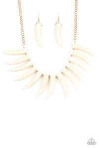 Infused with dainty gold beads, tusk-shaped white stone beads are threaded along an invisible wire below the collar, creating a wild fringe. Features an adjustable clasp closure.  Sold as one individual necklace. Includes one pair of matching earrings.