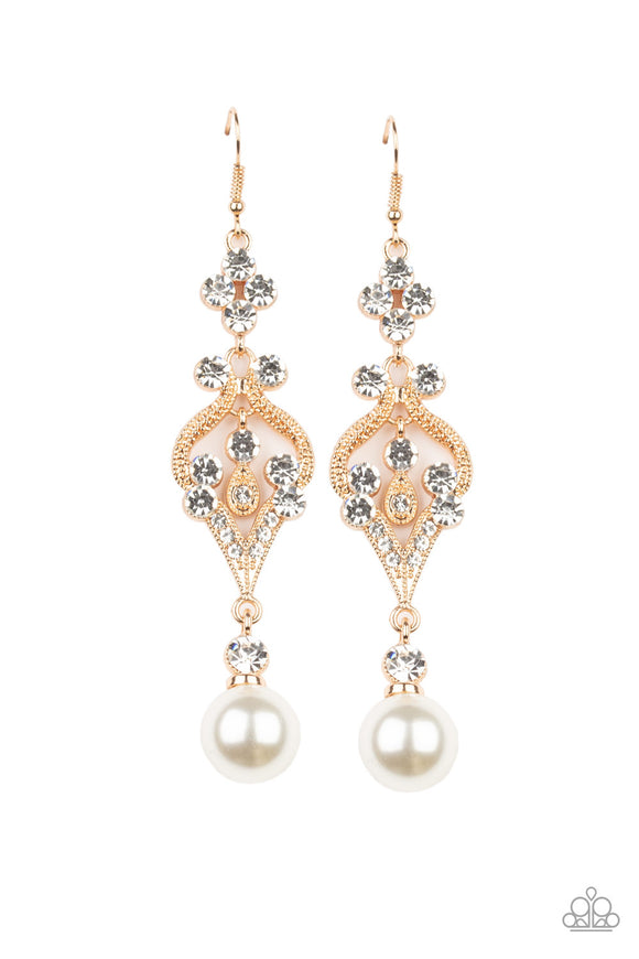 An oversized white pearl dangles from the bottom of a flowery gold frame dotted in sections of glassy white rhinestones for an elegant look. Earring attaches to a standard fishhook fitting.  Sold as one pair of earrings.