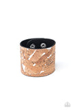 Pieces of cork have been plastered across the front of a shiny silver leather band, creating an earthy look around the wrist. Features an adjustable snap closure.  Sold as one individual bracelet.