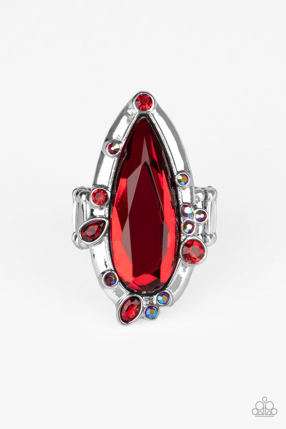 Varying in color and shape, mismatched red and iridescent rhinestones sporadically dot the front of a shiny silver teardrop frame. Featuring a flashy faceted surface, an oversized red teardrop gem adorns the center for a dazzling finish. Features a stretchy band for a flexible fit.  Sold as one individual ring.