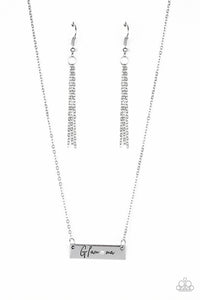 Dotted with a dainty white rhinestone, a silver rectangular frame stamped in the sassy word, "Glam-ma", is suspended below the collar by a dainty silver chain for a glamorous look. Features an adjustable clasp closure.  Sold as one individual necklace. Includes one pair of matching earrings.