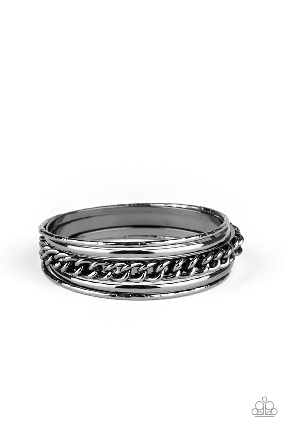 Pairs of smooth and textured gunmetal bangles join an antiqued bangle around the wrist that is decorated in a single strand of gunmetal chain for a gritty finish.  Sold as one set of five bracelets.