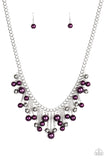 Attached to silver chains, a bubbly collection of purple pearls and shiny silver beads cascade from a thick silver chain, creating a flirtatious fringe below the collar. Features an adjustable clasp closure.  Sold as one individual necklace. Includes one pair of matching earrings.