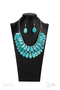 Three trailblazing tiers of shiny silver beads and turquoise teardrops fearlessly cascade into a bold tribal inspired fringe below the collar. Attached to a chunky silver chain, the groundbreaking stone compilation delicately layers into an earth-rattling statement-maker. Features an adjustable clasp closure.  Named after 2020 Rock the Runway winner, Amy K.  Sold as one individual necklace. Includes one pair of matching earrings.