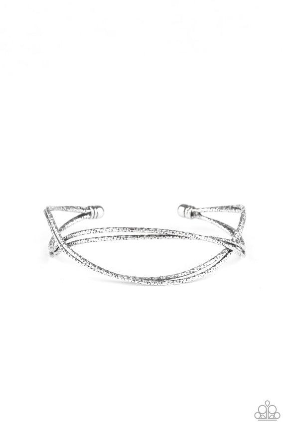 Featuring diamond-cut texture, dainty silver bars delicately crisscross over and around the wrist, coalescing into an airy cuff.  Sold as one individual bracelet.