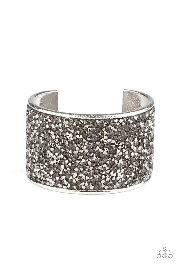 A brilliant collision of hematite and smoky rhinestones are encrusted across the front of a thick silver cuff, creating a stellar sparkle.  Sold as one individual bracelet.