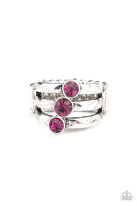 A trio of pink rhinestones slant across three stacked silver bands, coalescing into a refined centerpiece. Features a stretchy band for a flexible fit.  Sold as one individual ring.