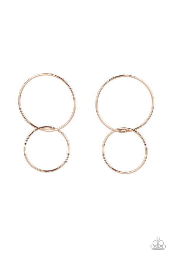 A gold hoop swings from the bottom of a dramatically oversized gold hoop, creating a gorgeously stacked lure. Earring attaches to a standard post fitting.  Sold as one pair of post earrings.