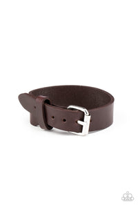 Gradually narrowing in width, a plain brown leather band buckles around the wrist for a rustic flair. Features an adjustable buckle closure.