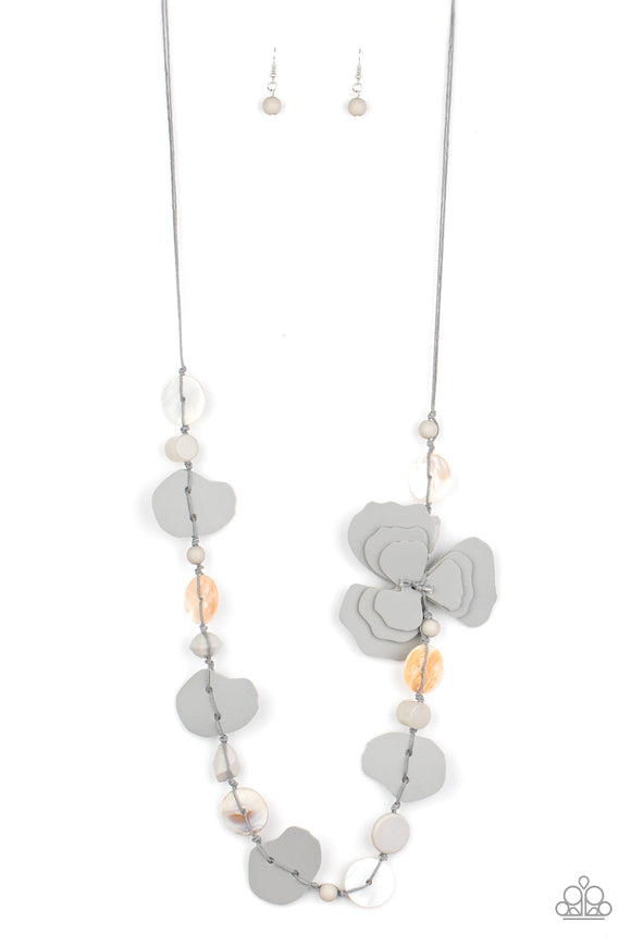 A colorful compilation of shell-like discs, mismatched gray acrylic beads, and petal-like gray leather pieces knot along strands of gray cording across the chest. The ruffled pieces of leather stack into a whimsical floral accent for a trendy finish. Features an adjustable clasp closure.  Sold as one individual necklace. Includes one pair of matching earrings.