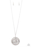 Encrusted in sections of glittery white rhinestones, glistening silver bars swirl inside a white rhinestone encrusted circle, creating a dizzying pendant at the bottom of a lengthened silver chain. Features an adjustable clasp closure.  Sold as one individual necklace. Includes one pair of matching earrings.