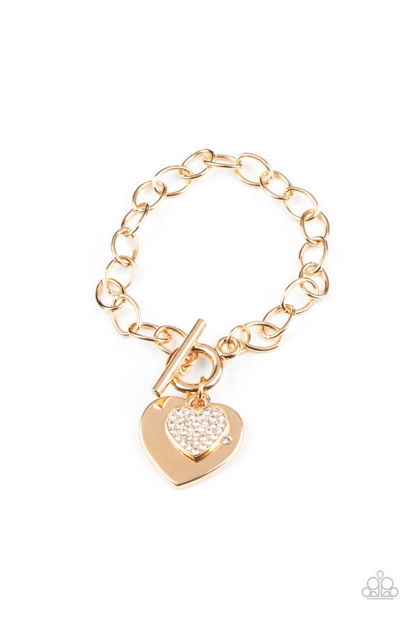 Dotted with a dainty white rhinestone, an oversized gold heart frame joins a glittery white rhinestone encrusted heart frame at the bottom of a chunky gold chain around the wrist for a charming look. Features a toggle closure.  Sold as one individual bracelet.