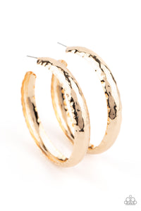 A thick piece of gold has been heavily hammered and delicately curved into a dramatically handcrafted hoop. Earring attaches to a standard post fitting. Hoop measures approximately 2 ½” in diameter.  Sold as one pair of hoop earrings.