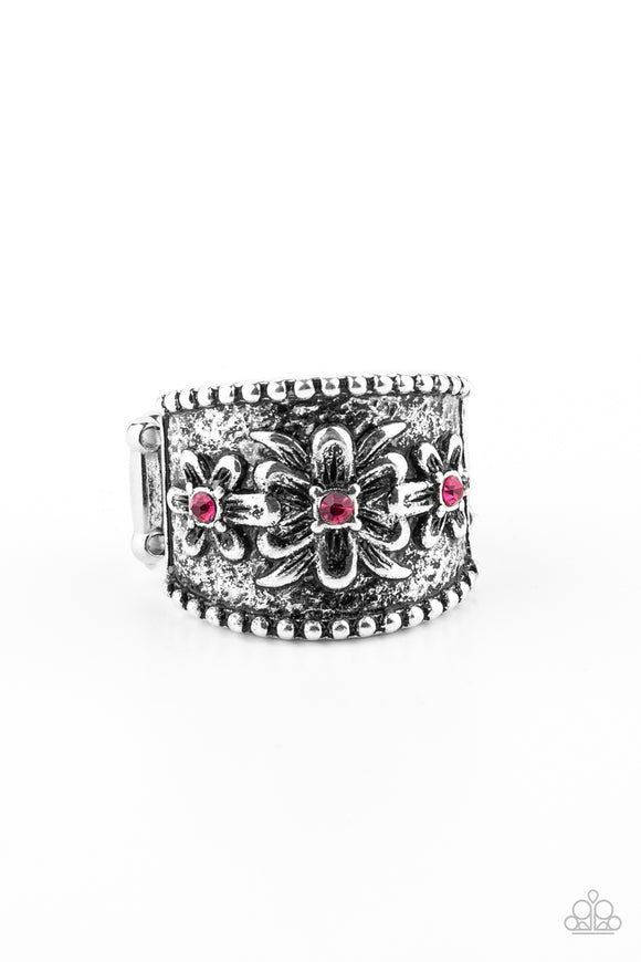 Dotted with dainty Pink Peacock rhinestone centers, tropical inspired flowers are embossed across the front of an antiqued studded silver band for a whimsical display. Features a stretchy band for a flexible fit.  Sold as one individual ring.