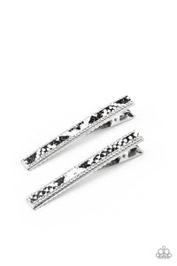 Bordered in glassy white rhinestones, a strip of black and white python print leather embellishes the front of a rectangular silver frame for a wild look. Features a standard hair clip on the back.  Sold as one pair of hair clips.