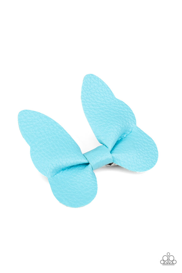 Featuring scalloped edges, a piece of blue leather delicately knots into a beautiful butterfly. Features a standard hair clip on the back.  Sold as one individual hair clip.