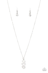 Encrusted in sparkly white rhinestones, a trio of glittery heart frames delicately stack into a charming pendant that swings from a dainty silver chain below the collar for a flirty finish. Features an adjustable clasp closure.  Sold as one individual necklace. Includes one pair of matching earrings.