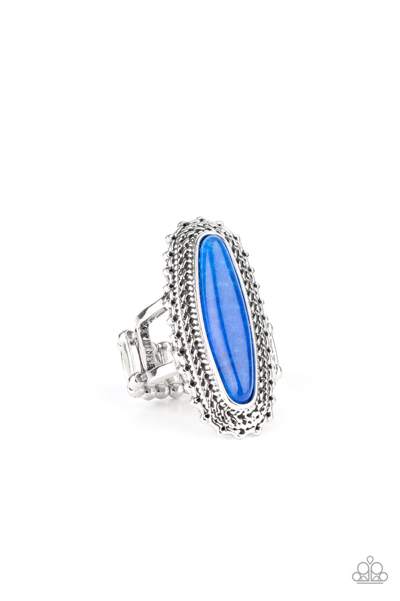 An oblong blue stone adorns the center of an elongated silver frame featuring mismatched silver textures for a bold artisan look. Features a stretchy band for a flexible fit.  Sold as one individual ring.
