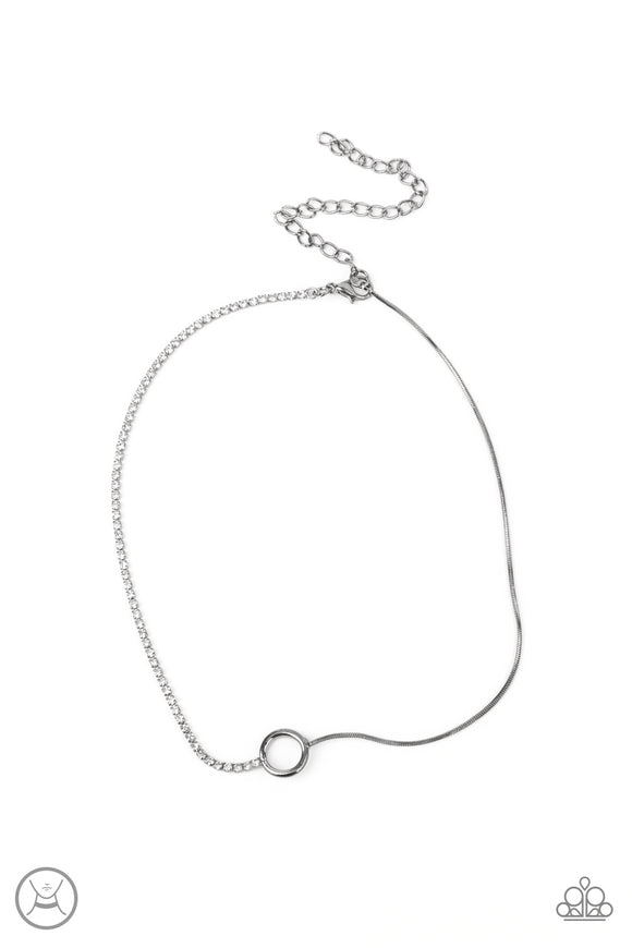 A dainty gunmetal ring splits into a glittery strand of glassy white rhinestones and a rounded gunmetal snake chain around the neck for an unpredictable finish. Features an adjustable clasp closure.  Sold as one individual choker necklace. Includes one pair of matching earrings.
