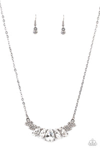 Featuring a dramatically oversized white teardrop rhinestone center, dainty white rhinestone encrusted gunmetal frames connect with pairs of glassy marquise cut rhinestones below the collar for a sparkly statement-making look. Features an adjustable clasp closure.  Sold as one individual necklace. Includes one pair of matching earrings.