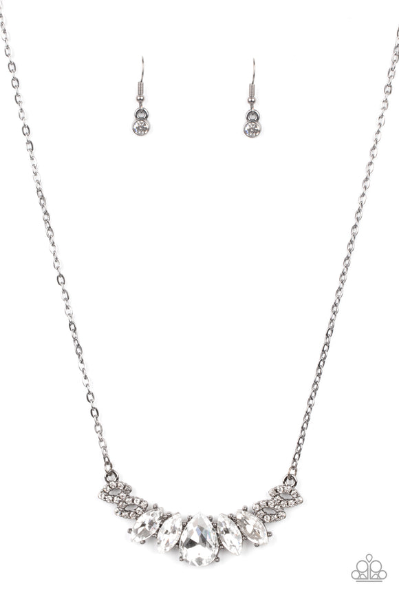 Featuring a dramatically oversized white teardrop rhinestone center, dainty white rhinestone encrusted gunmetal frames connect with pairs of glassy marquise cut rhinestones below the collar for a sparkly statement-making look. Features an adjustable clasp closure.  Sold as one individual necklace. Includes one pair of matching earrings.