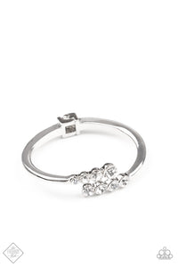 Attached to two thick silver bars, oversized rows of glittery white rhinestones delicately stack into a hypnotizing centerpiece around the wrist. Features a hinge closure.  Sold as one individual bracelet.