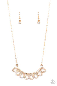 A white rhinestone encrusted gold ribbon delicately loops below the collar, coalescing into a timelessly stationary statement piece. Features an adjustable clasp closure.  Sold as one individual necklace. Includes one pair of matching earrings.