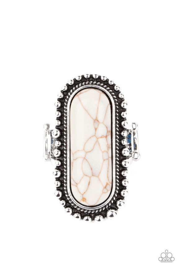 An oblong white stone is nestled inside an oversized studded silver frame, creating a colorfully rustic centerpiece atop the finger. Features a stretchy band for a flexible fit.  Sold as one individual ring.