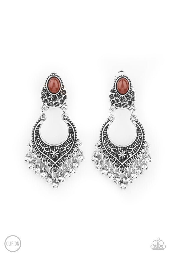 Infused with a silver beaded fringe, an ornate floral embellished frame attaches to a brown beaded frame for a whimsically stacked look. Earring attaches to a standard clip-on fitting.  Sold as one pair of clip-on earrings.
