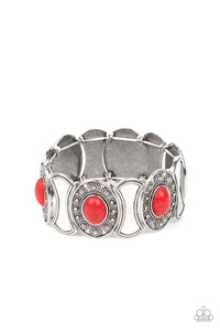 Dotted in ornate silver studs, red stone embellished silver frames join hammered silver plates along stretchy bands around the wrist for a colorful seasonal flair.  Sold as one individual bracelet.