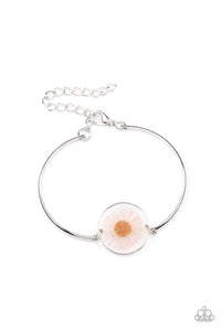 Encased in a glassy fitting, a whimsical pink daisy centerpiece attaches to two arcing silver bars around the wrist for an enchanting floral look. Features an adjustable clasp closure.  Sold as one individual bracelet.