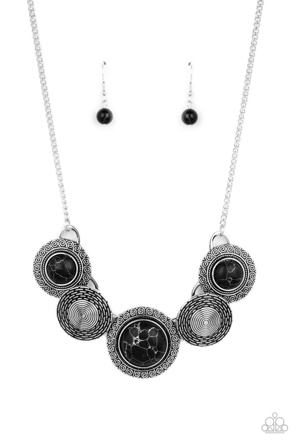 Embossed in swirly patterns, black stone frames link with antiqued silver frames radiating with spiral textures below the collar for a seasonal inspired flair. Features an adjustable clasp closure.  Sold as one individual necklace. Includes one pair of matching earrings.