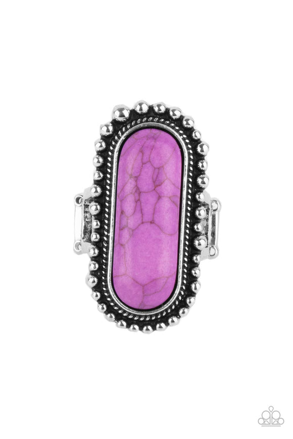 An oblong purple stone is nestled inside an oversized studded silver frame, creating a colorfully rustic centerpiece atop the finger. Features a stretchy band for a flexible fit.  Sold as one individual ring.