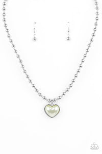 Featuring a pearly Green Ash center, a charming heart pendant glides along a strand of silver beads below the collar for a romantic flair. Features an adjustable clasp closure.  Sold as one individual necklace. Includes one pair of matching earrings.