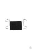 Black suede cording wraps around a silver fitting nestled between an airy silver cuff, creating a colorfully rustic centerpiece.  Sold as one individual bracelet.