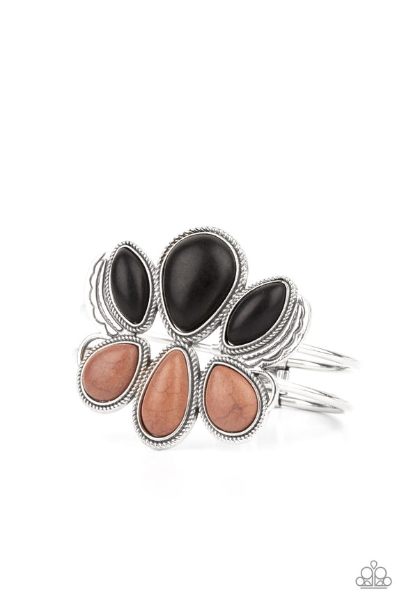Encased in antiqued silver rope-like frames, a colorful collection of black and brown stone teardrops stack into a rustic centerpiece atop a layered silver cuff. Features an adjustable hinged closure.  Sold as one individual bracelet.