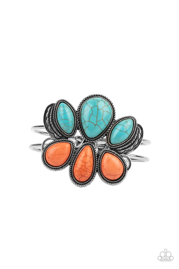 Encased in antiqued silver rope-like frames, a colorful collection of turquoise and orange stone teardrops stack into a rustic centerpiece atop a layered silver cuff. Features an adjustable hinged closure.  Sold as one individual bracelet.