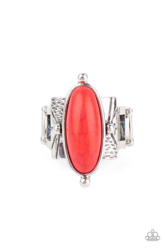 An oval red stone is nestled inside a studded silver fitting that sits atop a decorative silver frame stamped in tribal inspired textures, creating a rustic centerpiece. Features a stretchy band for a flexible fit.  Sold as one individual ring.