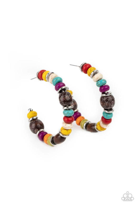 An earthy collection of multicolored stone beads, silver discs, and brown wooden beads are delicately threaded along a dainty wire, creating an artisan inspired hoop. Earring attaches to a standard post fitting. Hoop measures approximately 2