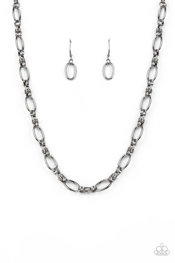 Pairs of joined gunmetal links connect a collection of gunmetal oval frames below the collar, creating an edgy chain. Features an adjustable clasp closure.  Sold as one individual necklace. Includes one pair of matching earrings.
