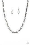 Pairs of joined gunmetal links connect a collection of gunmetal oval frames below the collar, creating an edgy chain. Features an adjustable clasp closure.  Sold as one individual necklace. Includes one pair of matching earrings.