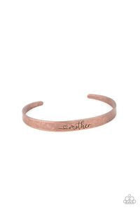 A dainty copper cuff is stamped in a heart and the word, "Mother," creating a rustic sentimental centerpiece around the wrist.  Sold as one individual bracelet.