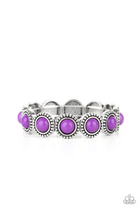 Featuring an antiqued silver studded edge, silver frames encase polished purple beads. The eye-catching series of fanciful beads are threaded along a stretchy band and promenade around the wrist for a whimsical look.  Sold as one individual bracelet.